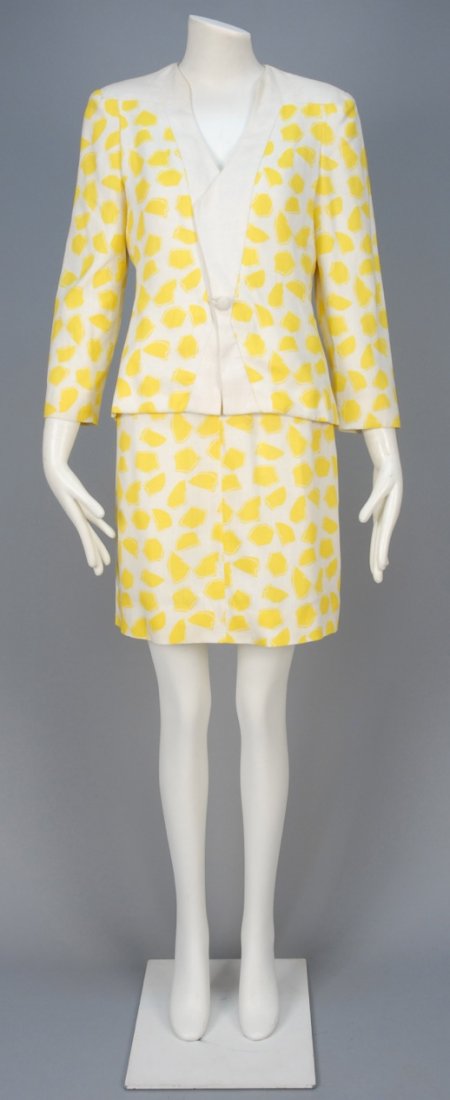 CAROLINA HERRERA THREE PIECE SUMMER SUIT, 1980s.: White rayon/linen blend with abstract lemon print, collarless jacket with single self buttons and white trim, peplum camisole with self buttons and narrow A-line skirt, silk lining. Labeled. B-34, W-2