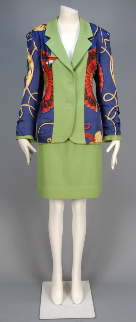 MOSCHINO SILK and WOOL SKIRT SUIT, 1980s.: Pistachio wool with polychrome printed silk overlay on jacket with fans, carnations, rope, etc., matching narrow skirt. Pret-a-Porter label. B-38, Sh-18, Slv-25, W-30, H-40, skirt L-23 1/2. Excellent.