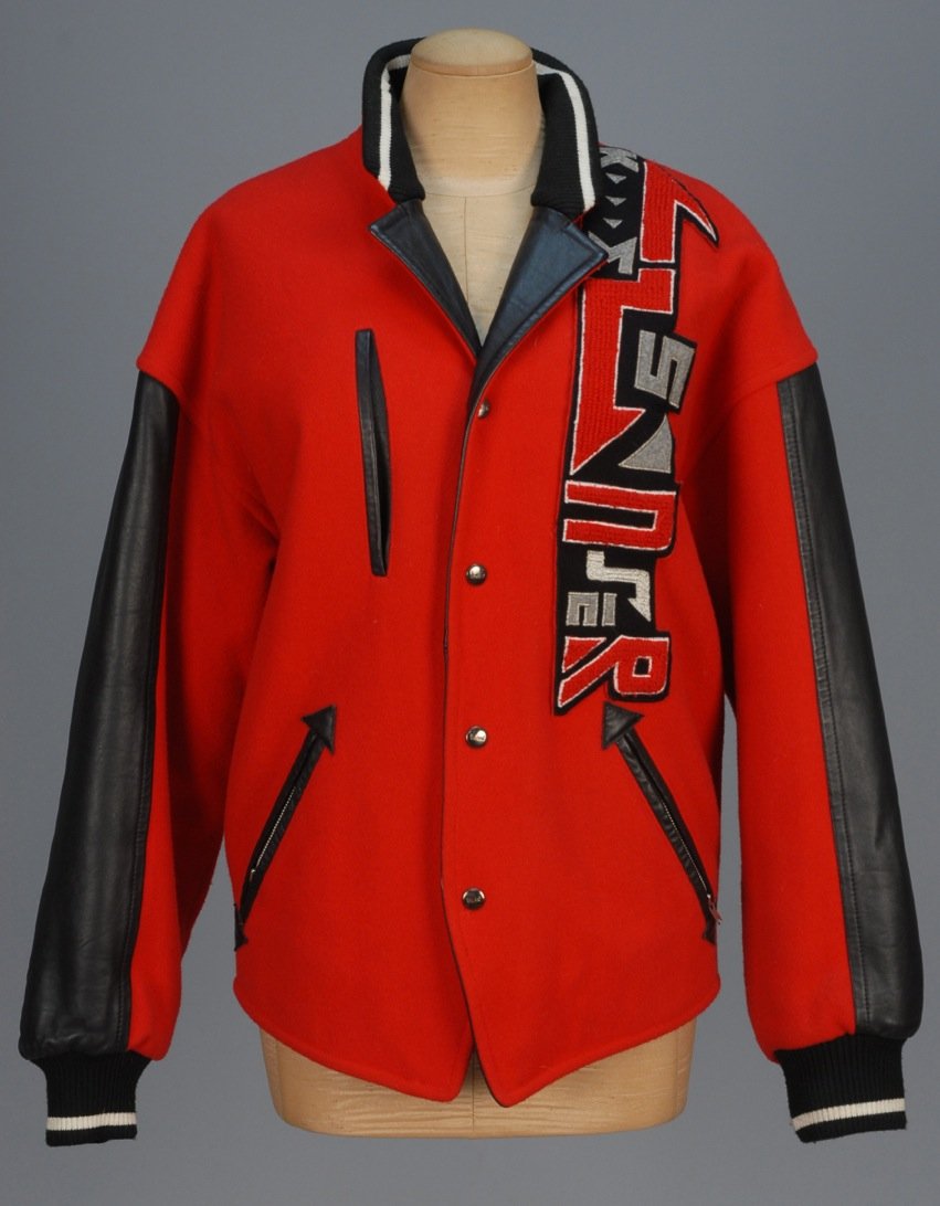 KANSAI O2 APPLIQUED VARSITY JACKET, 1980s.: Red wool with black leather trim having wool and metallic applique decoration, snap closures and quilted lining. Labeled. B-50, L-27. Excellent.