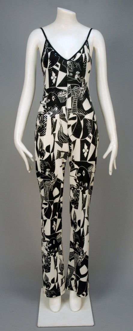GUERNICA PRINT JUMPSUIT.: Synthetic knit in black and white print with reflective disks depicting Picasso's "Guernica", narrow strap and flared leg. Unlabeled. B-36, W-32, H-40, L-59. (One inch of bodice binding unstitched) ex