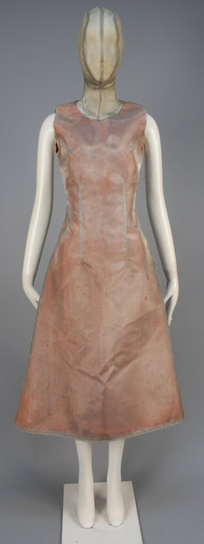 ALEXANDER McQUEEN MASKED MESH DRESS, THE HUNGER: Sleeveless silver nylon mesh having high neck supporting zippered mask completely encapsulating the head, the back cut in two pieces curving at hem into a right angle forming a fishtail, body of dress