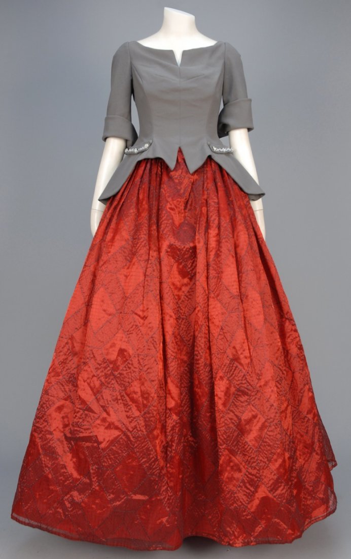 KARL LAGERFELD EMBROIDERED BALL GOWN.: Silk, cotton and polyester with pewter peplum bodice having elbow length sleeve with split pointed cuff, notched neckline and faux pockets with rhinestone trim, self buttons and long pointed back over