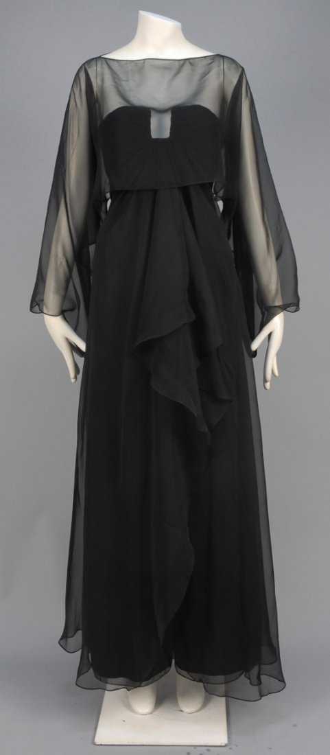 YVES SAINT LAURENT STRAPLESS SILK EVENING GOWN and: Black organza having ruched bodice with wired "U" shaped cutout, floating layer angled towards back hem over A-line skirt with front slit, sheer kimono cut cropped "jacket". Labeled. B-32, W-32, H-38,