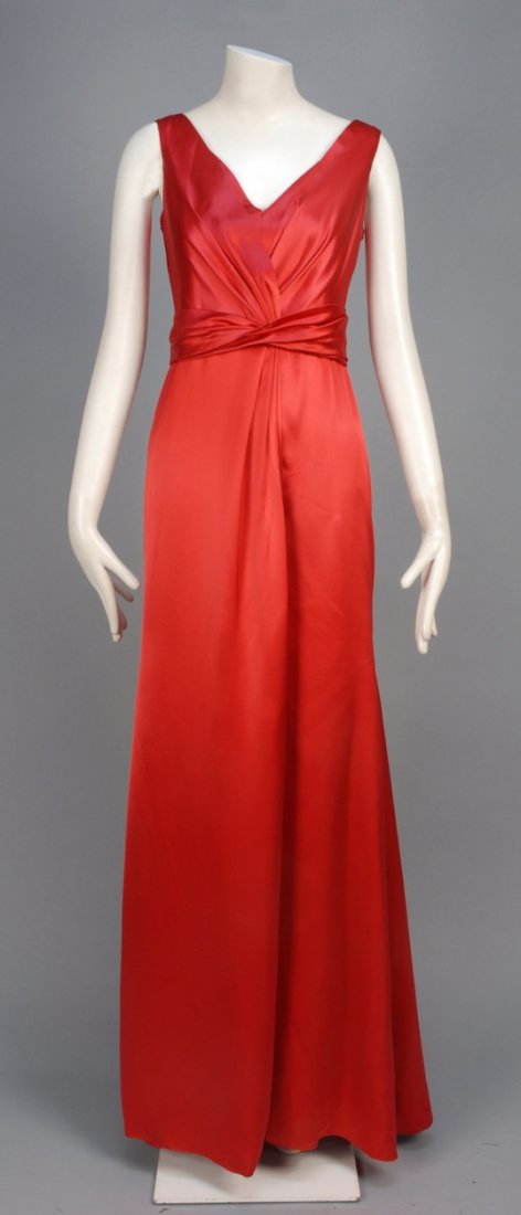 GIORGIO ARMANI SATIN EVENING GOWN.: Sleeveless red silk having faux wrap front, pleated self sash and A-line skirt, silk crepe lining. Collezioni label. B-36, W-30, H-40, L-61. Excellent.