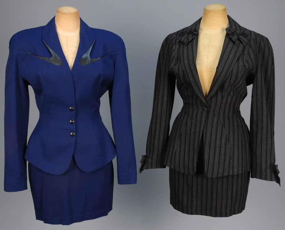 TWO THIERRY MUGLER WOOL SKIRT SUITS.: One blue gabardine with black leather-trimmed collar incorporated into breast pockets, faux leather buttons over snaps, matching skirt. B-36, W-24, H-36, skirt L-18 1/2. One black and white variegated