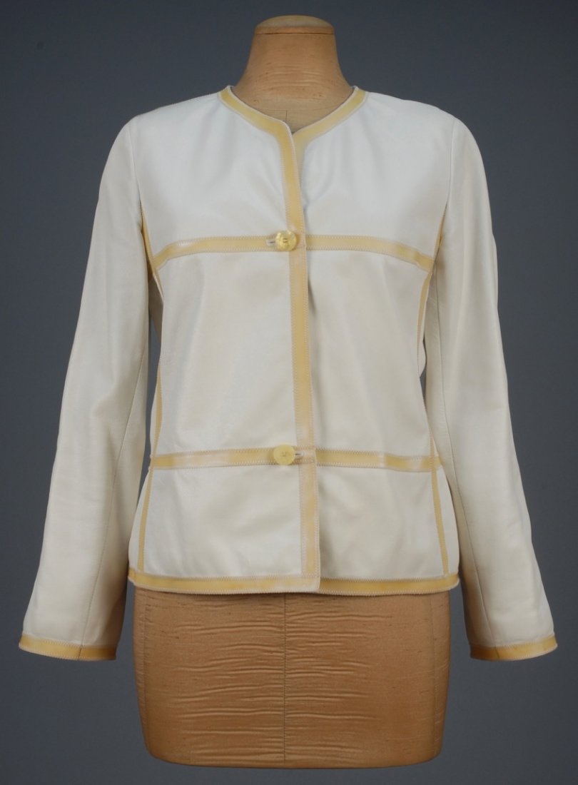 CHANEL LEATHER JACKET.: White lambskin having pale gold appliqued bands with topstitching, glittering logo buttons and silk lining. Labeled. Marked size 40. B-38, Sh-16, Slv-22 1/2, L-22. Excellent.