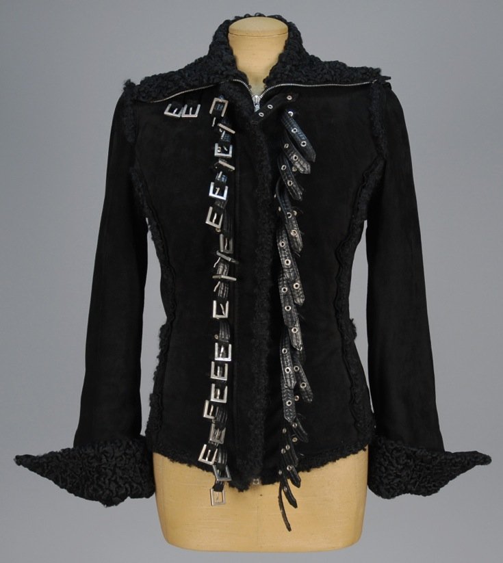 GIANFRANCO FERRE FAUX SHEARLING BUCKLE JACKET.: Black faux suede having zip front flanked by a series of straps and buckles, Persian lamb collar and cuff, side zip pockets. Labeled. B-36, W-30, L-24. (One buckle missing but not obvious) overall exc