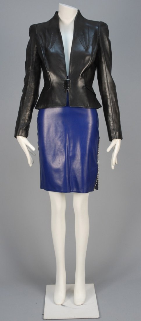 TWO DESIGNER LEATHER GARMENTS, 1980s.: One Thierry Mugler black collarless jacket with topstitched details, angled pockets, slit neckline and magnetic buckle, satin lining. B-36, Sh-15, Slv-26, W-28, L-21. One Claude Montana royal blue pen
