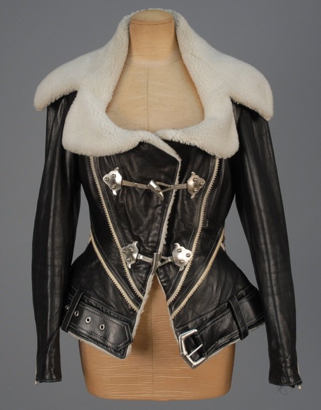 BYRON LARS LEATHER JACKET.: Black leather with cream faux shearling collar, cream suede sawtooth trim, with silvertone toggles and self belt. Labeled. B-36, Sh-17, Slv-24, W-28, L-27. Excellent.