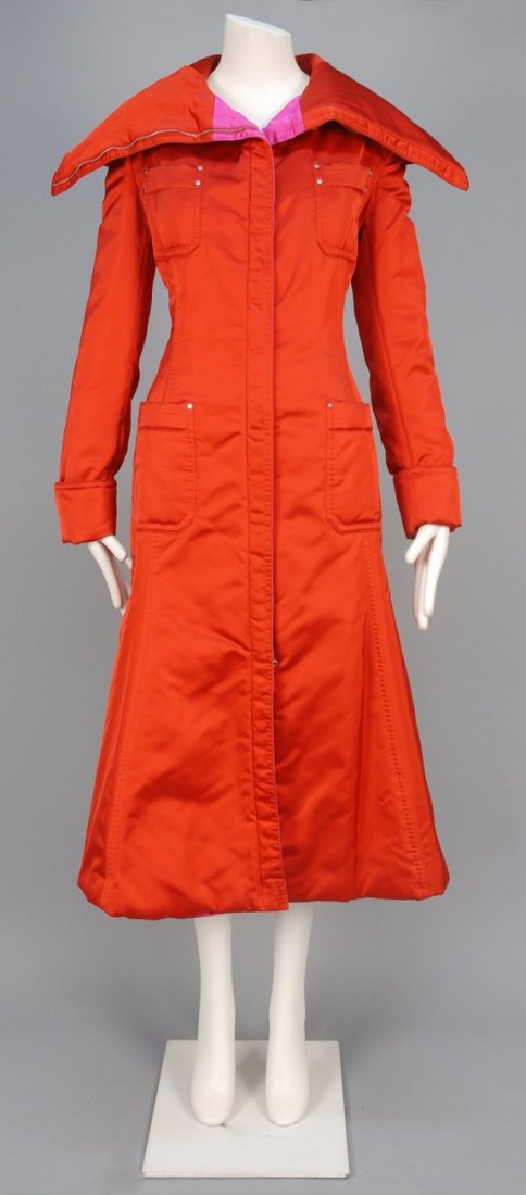 GIANFRANCO FERRE SATIN LONG COAT.: Zip-front red satin with tall fold-over collar, four patch pockets, topstitched and rivet details, hot pink facings and silk lining. Labeled. B-40, W-30, H-40, L-49. Excellent.