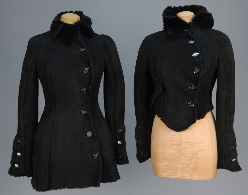 TWO VIVIENNE WESTWOOD BLACK SUEDE JACKETS.: Both having off-center oval logo buttons and faux shearling lining: One short length with single flap pocket. One long with vertical pockets. Labeled. Both B-32, W-26, L-20 and L-32. Excellent.