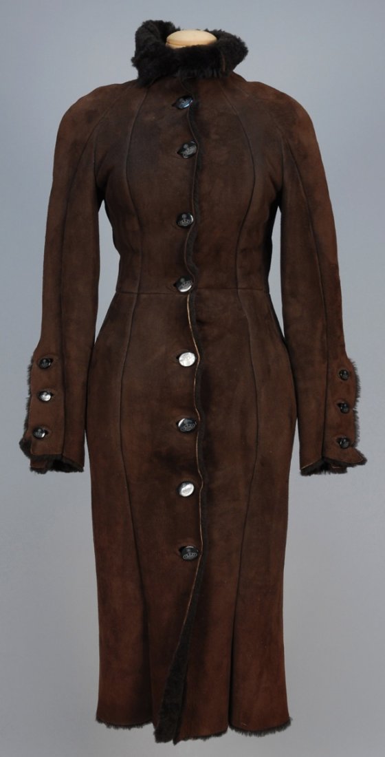 VIVIENNE WESTWOOD SUEDE COAT.: Brown with faux shearling lining, black oval logo buttons and vertical pockets. Labeled. B-32, W-26, L-48. Very good.
