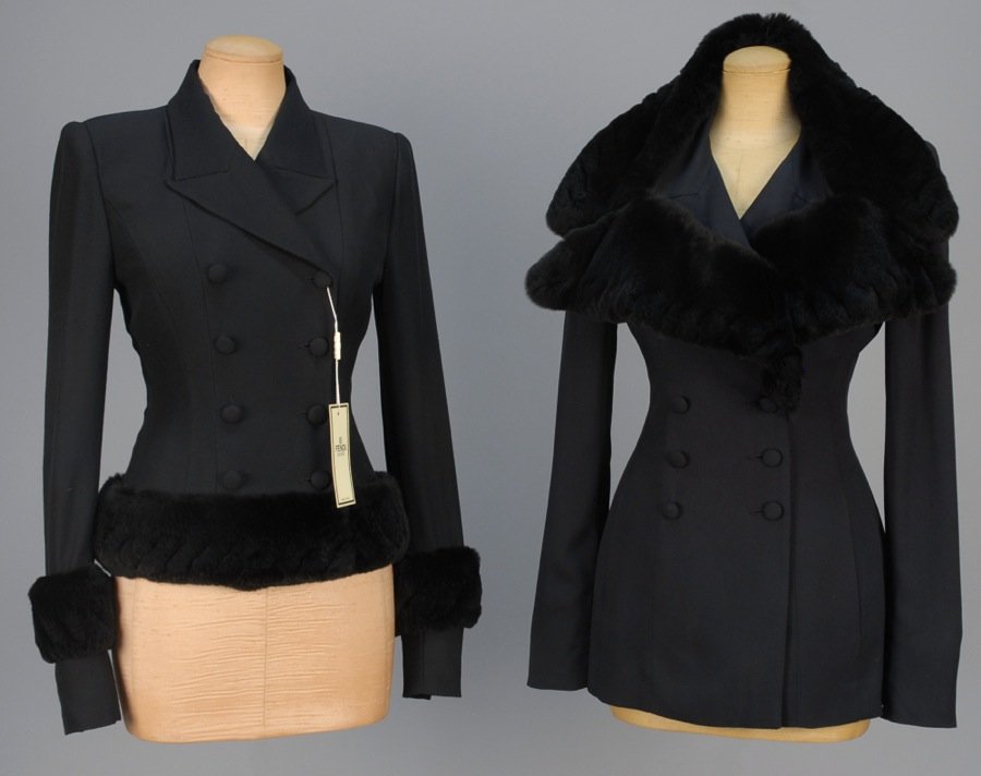 TWO FENDI FUR TRIMMED JACKETS.: Both double breasted black wool blend with black orylag trim having diagonal slits and self buttons: One long with fur collar, B-36, Sh-15, Slv-25, W-26, L-28. One deadstock with fur sleeve band and h