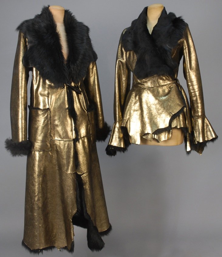 CUSTOM MADE METALLIC SHEARLING COAT and JACKET.: Both black and gold hide: One long coat with long fur lining, collar and cuff with raw unfinished edges, patch pockets and toggle closure. B-42, L-52. One wrap style jacket with wide sheared fur colla