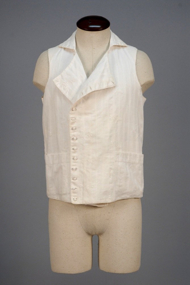 GENTS ENGLISH EMBROIDERED DIMITY WAISTCOAT, c. 1800.: GENTS ENGLISH EMBROIDERED DIMITY WAISTCOAT, c. 1800. Double breasted and collared white cotton in alternating vertical stripes having chevrons or diagonal lines, embroidered with widely spaced floral 