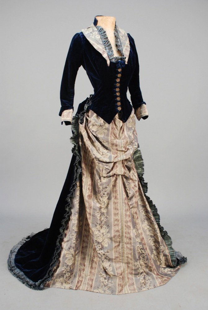TRAINED SILK BROCADE and VELVET BUSTLE DRESS, 1880s. (1 of 4)