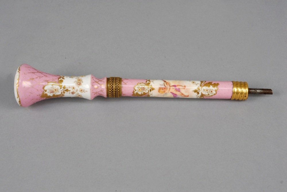 DRESDEN PARASOL HANDLE, LATE 19th - EARLY 20th C. Pink: DRESDEN PARASOL HANDLE, LATE 19th - EARLY 20th C. Pink and white porcelain painted with cherubs and gilt floral decoration. 8 1/2 x 1 3/4. (Some gilt losses) good.