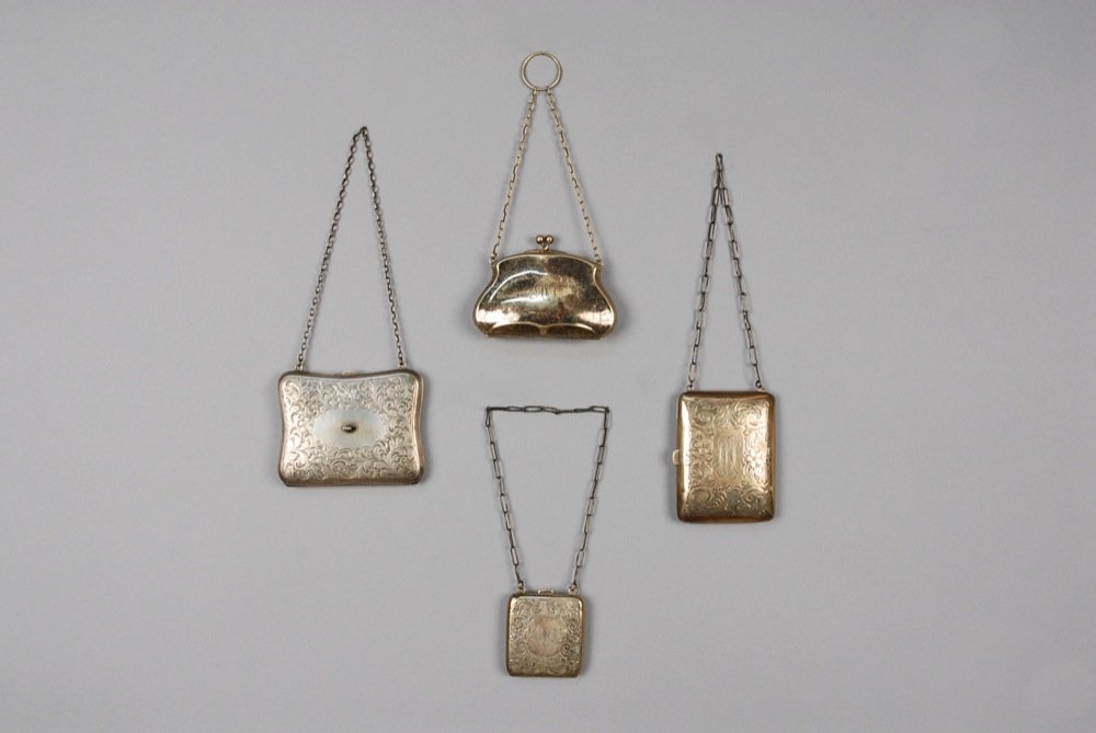FOUR STERLING SILVER PURSES or COMPACTS, 1910s - 1930s. (1 of 2)