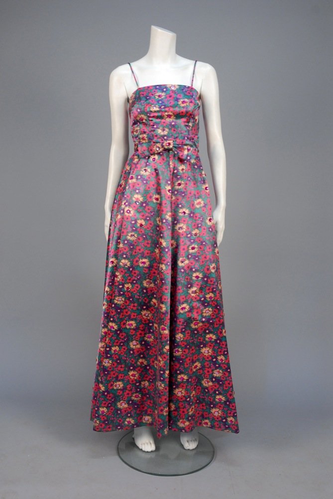PRINTED and SEQUINED SILK MAXI DRESS, c. 1968. Dull: PRINTED and SEQUINED SILK MAXI DRESS, c. 1968. Dull satin in polychrome floral studded with pink and fuchsia sequins, having semi-boned bodice with spaghetti strap and stiffened full skirt, self belt 