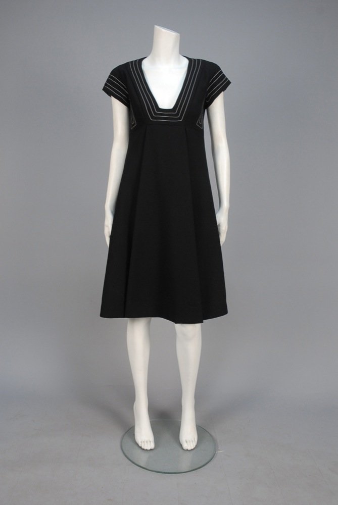RONALD AMEY TOPSTITCHED WOOL DAY DRESS, 1970s. Black: RONALD AMEY TOPSTITCHED WOOL DAY DRESS, 1970s. Black A-line with cap sleeve and truncated V-neck decorated with white topstitching, high waisted skirt having center box pleat and side seam pockets. La