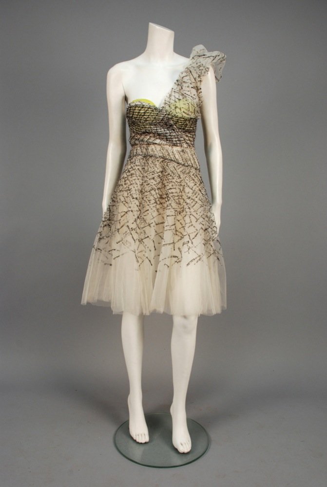 OSCAR de la RENTA ONE-SHOULDER COCKTAIL DRESS. White: OSCAR de la RENTA ONE-SHOULDER COCKTAIL DRESS. White tulle having one pleated shoulder puff, appliqued with grey splatter-printed strips of white voile with raw, frayed edges and black beaded lines, f