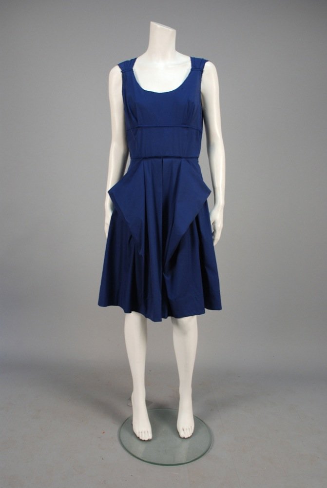 PRADA INSIDE OUT PINAFORE DRESS. Blue cotton having: PRADA INSIDE OUT PINAFORE DRESS. Blue cotton having exposed raw seams, wide straps pleated into pieced bodice with tucks, box pleated full skirt having large front pockets created by folds. Labeled. B