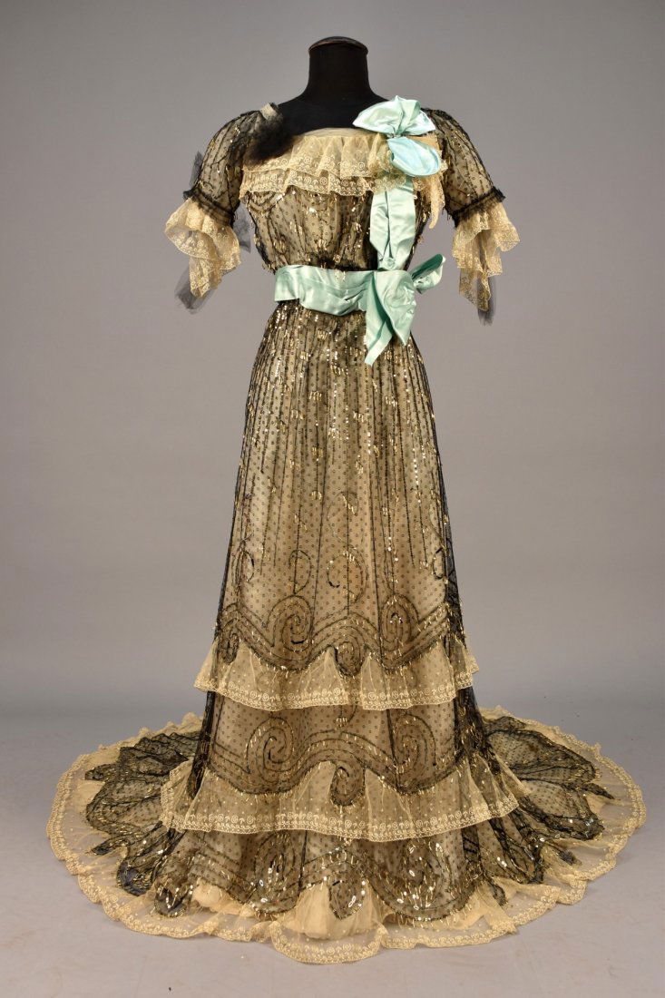 JEANNE HALLE TRAINED POINT-dÕESPRIT EVENING DRESS, c.: 2-piece black dotted net decorated with gold sequins and bugle bead dangles in a pattern of scrolls and vertical lines, the boned short sleeve bodice trimmed in embroidered net, black and white tulle,