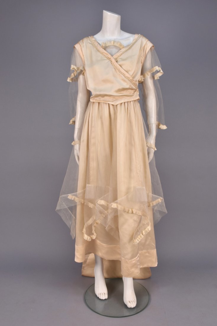 FRENCH SILK and TULLE WEDDING GOWN, c. 1916.: Ivory charmeuse having surplice bodice with collared tulle long sleeve trimmed in pleated silk, the neckline decorated with tulle insert and pearl beads, skirt having tulle overlay with large handkerc