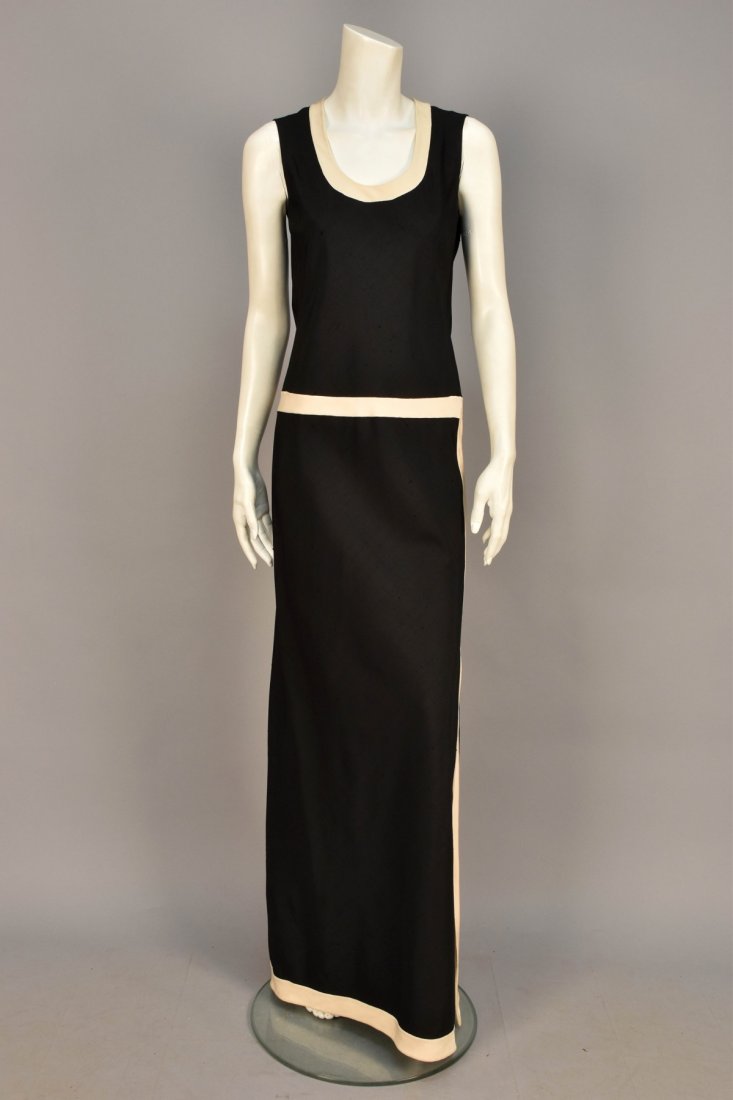 MILA SCHON SILK LONG DRESS, 1960s.: Sleeveless black raw silk having cream trim band to scoop neck, waist, hem and left side with slit to knee. Labeled. B-36, W-32, H-39, L-61 1/2. (Few faint stains at hem) very good.