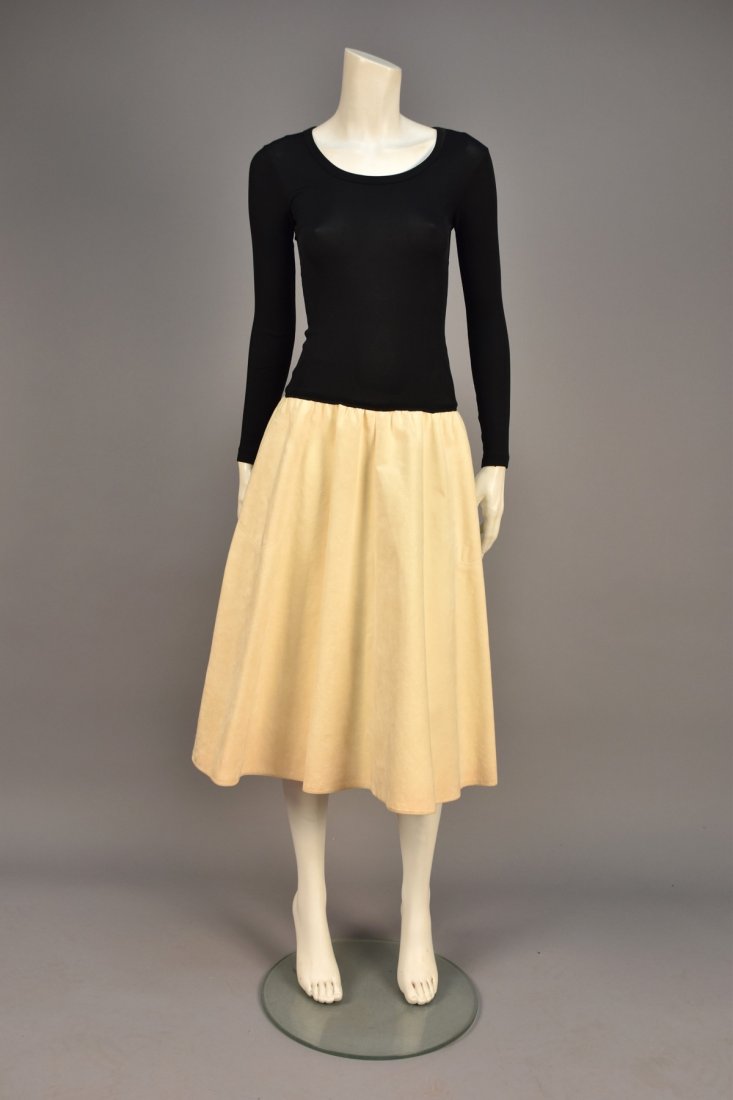 VERA MAXWELL SPEED SUIT DRESS, c. 1975.: Long sleeve black jersey bodice with slight scoop neck and gathered winter white Ultrasuede skirt having topstitched side seam pockets and hem. Labeled. B-up to 34, elastic W-up to 28, L-47. (Faint so