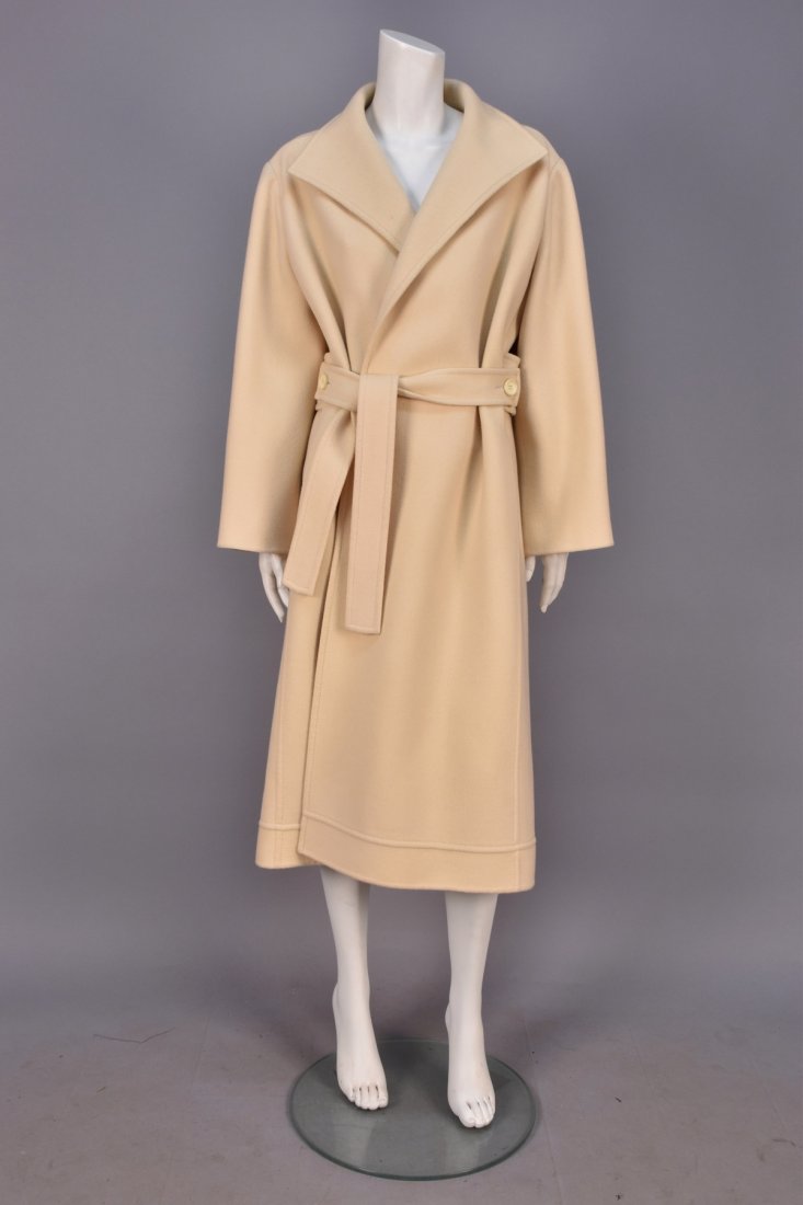 MARC BOHAN for CHRISTIAN DIOR WOOL COAT, SPRING-SUMMER: Off-white wrap style with wide lapel, topstitched yoke and seam details, self ties buttoning onto a wide half belt at back, side seam pockets, upper half silk lined. 1973 Paris collection label stampe