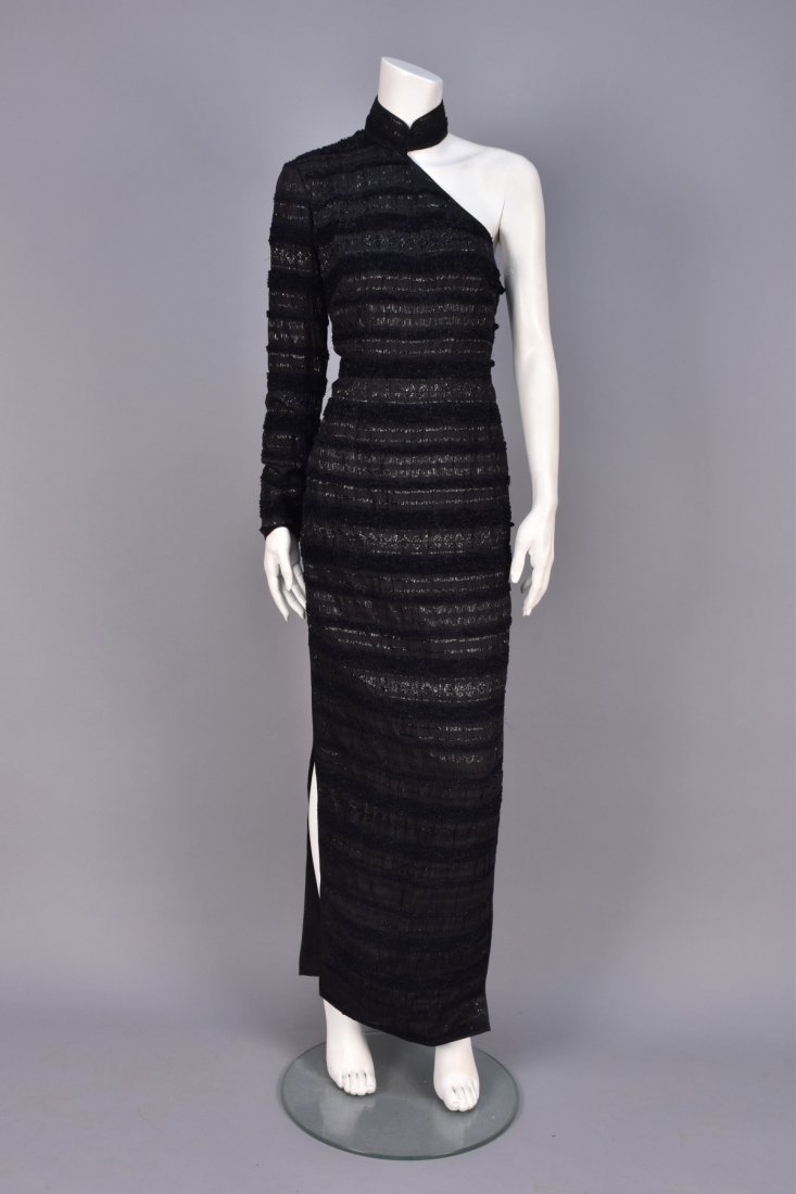 SHANGHAI TANG ONE-SHOULDER CHEONGSAM.: Black puckered silk sheath having bands of clipped chenille and reflective threads, Mandarin collar with frogs, long sleeve, side slits, satin bindings and faux frogs at side zipper. Labeled. B-38, W-