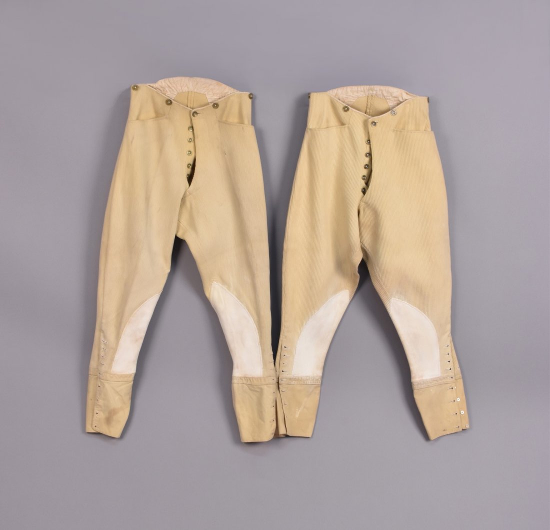 TWO PAIR MENS HAMMOND & CO. JODPHURS, 1920s - 1930s: Ribbed ivory wool having button fly, angled pockets, white suede leg patches, felt cuff, mother-of-pearl leg buttons, gold-tone fly buttons, suspender buttons marked "Hammond & Co, Oxford St": One W-2