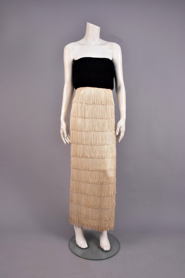 2-TONE STRAPLESS FRINGED EVENING DRESS, 1940s: Black crepe semi-boned bodice with two rows of black fringe, long ivory skirt with side slit, covered in rows of fringe, corset added. B-36, W-26, H-36, L-46. (Alterations, faint stain near waist, lin