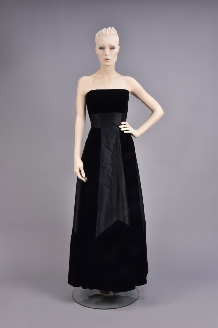 HATTIE CARNEGIE STRAPLESS BALL GOWN, 1950s: Velvet bodice with wide silk waistband over boned sweetheart under-bodice, full skirt inset with wide silk panels cut to an inverted V below the knee, taffeta underskirt, labeled. B-34, W-23, L-51. Ex