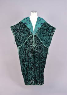 THEA PORTER VOIDED VELVET CAFTAN, 1970s.: Square-cut green silk velvet voided to chiffon in an abstract floral, inset with green silk triangle at front and back neck decorated with embroidery and blue iridill bugle beads, trimmed in green sil