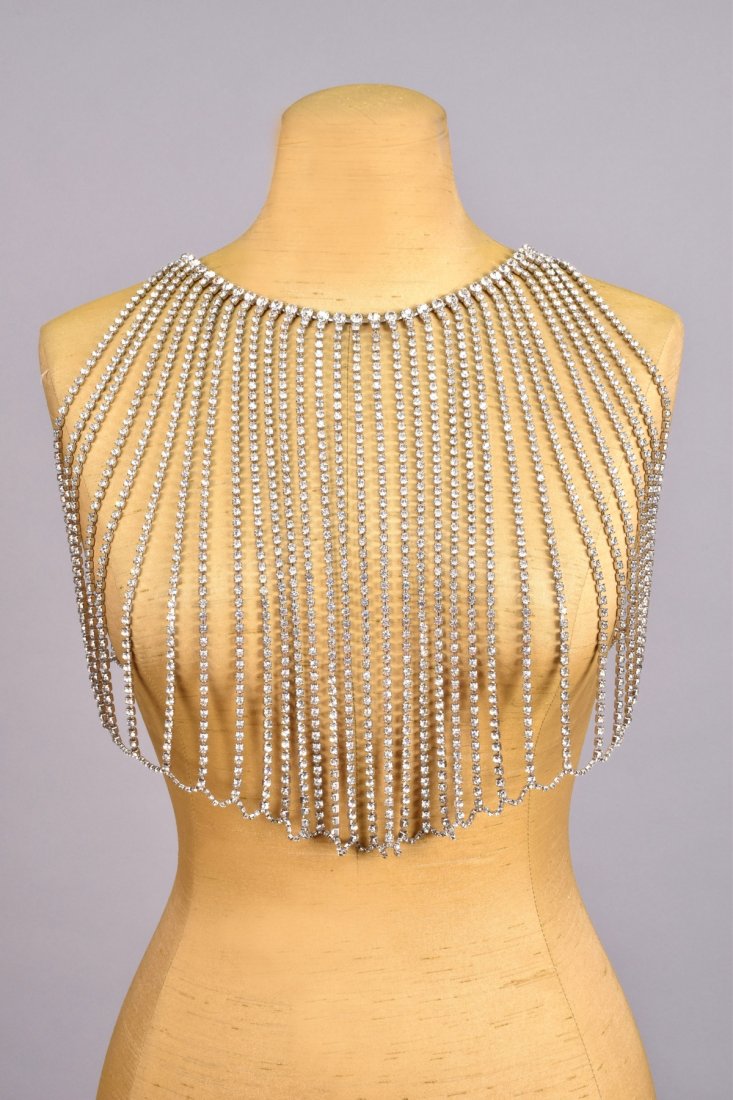 RARE BILL SMITH BODY JEWELRY RHINESTONE BODICE, c.: Comprised of strands of prong-set rhinestones radiating from neckline to hem band, hook and chain closure with rhinestone ball finial. Excellent.
