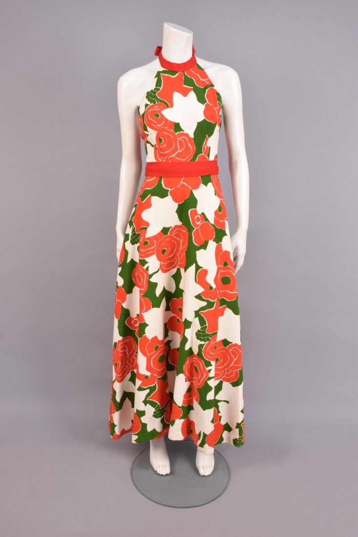 PIERRE CARDIN POPPY PRINT HALTER GOWN, 1960s.: White cotton piquÃ© with red and green stylized print, red knit neck band/tie and wide sash, full skirt. Labeled. B-34, W-24, L-56. (Few barely noticeable stains) very good. GLC