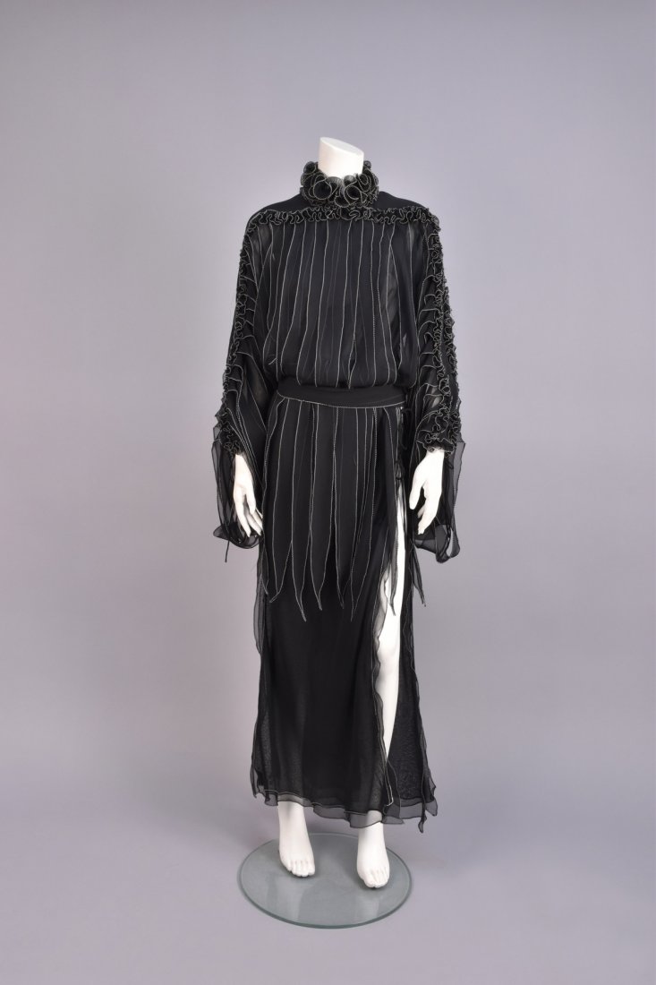 AVANT GARDE TABARD, 1970s.: Black tissue silk bodice with long, layered voile front and back panels, ruffled high collar and yoke cut as one with top of long sleeve, pointed streamers suspended from the yoke and stitched into th