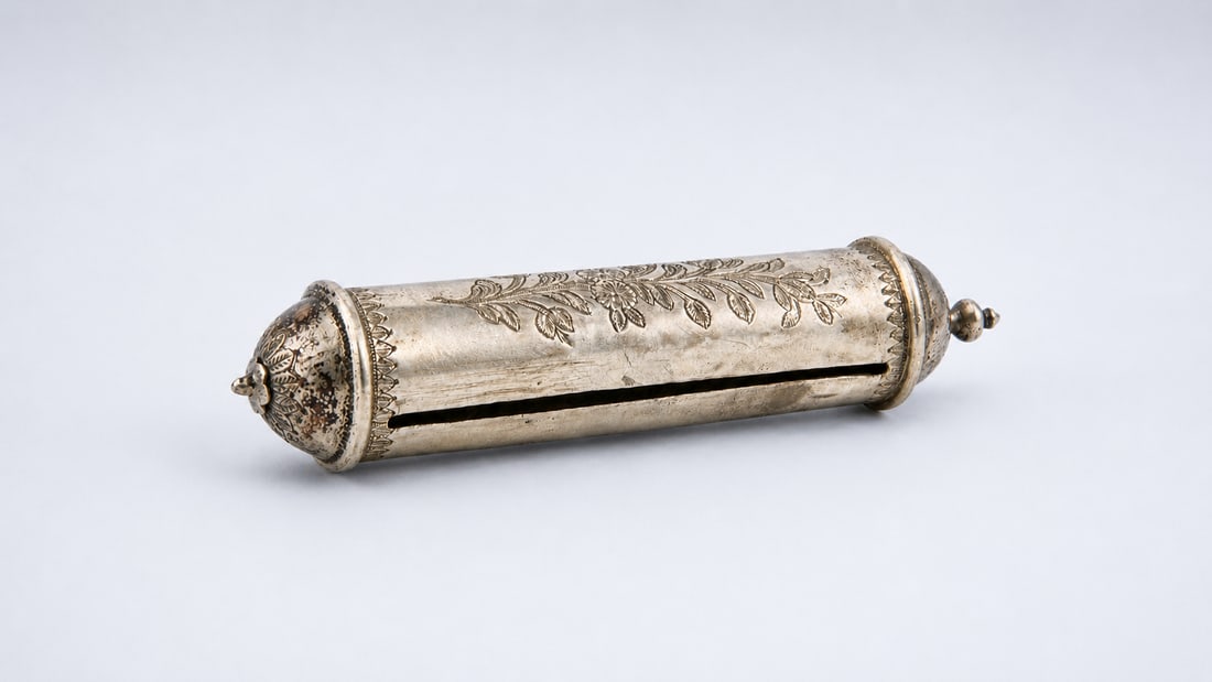 AN OTTOMAN SILVER-PLATED CYLINDRICAL PEN OR DOCUMENT HOLDER (KUBUR), 19TH CENTURY: A finely crafted Ottoman cylindrical pen or document holder (kubur), dating to the 19th century, of elongated form with domed terminals and a fitted opening mechanism. The surface is decorated with ch