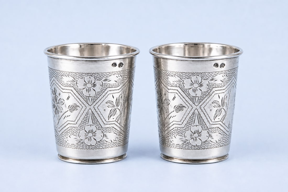 A PAIR OF OTTOMAN SILVER CUPS WITH TUGHRA OF SULTAN ABDULHAMID II (R. 1876–1909): A fine pair of Ottoman silver cups bearing a tughra attributed to Sultan Abdulhamid II (reigned 1876–1909), each of slightly tapering cylindrical form. The surfaces are finely decorated with engrave