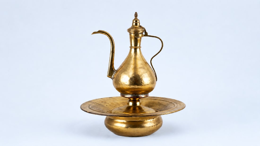 AN OTTOMAN MARKET METAL EWER AND BASIN SET (IBRIK), RUSSIAN (TSARIST), LATE 19TH CENTURY: A finely crafted ewer and basin set (ibrik and le?en), produced in the late 19th century, likely within the Russian Imperial sphere (Tsarist Russia) for the Ottoman market. Such cross-cultural works r