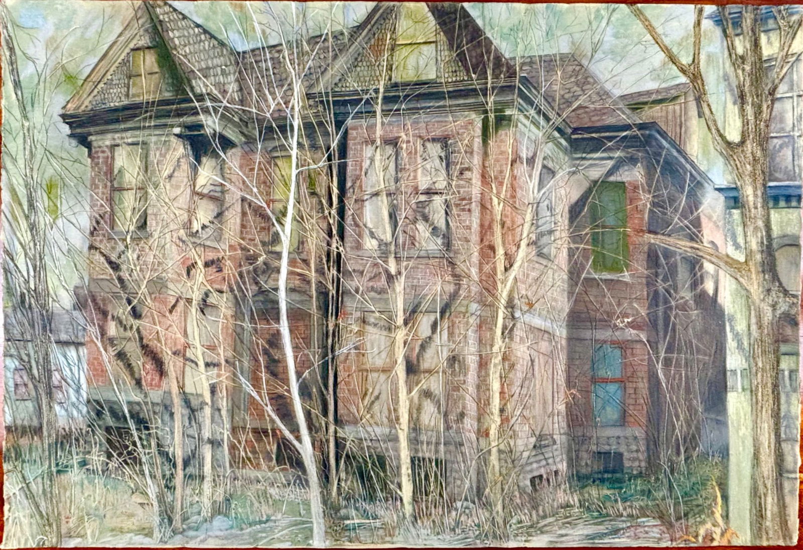 Pastel on Paper Depicting an Abandoned House in a Forested Setting: Pastel on paper artwork featuring a detailed depiction of an abandoned two-story house with a brick facade, surrounded by barren trees and overgrown grass. The composition emphasizes textures and laye