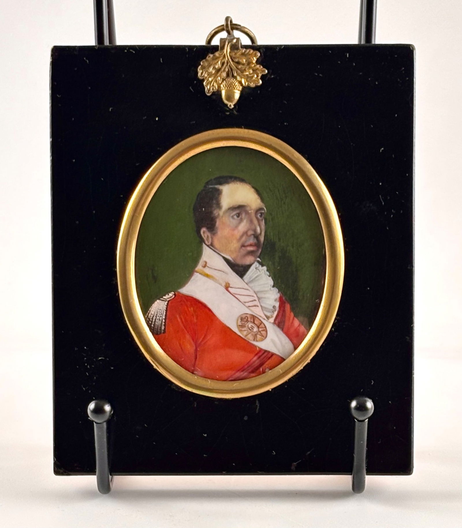 19th Century Portrait Miniature of a Soldier in Gilt Frame: Portrait miniature of a soldier, likely hand-painted on ivory or similar material, housed in an oval gilt metal frame. The subject is depicted in a military uniform with detailed epaulettes and a meda