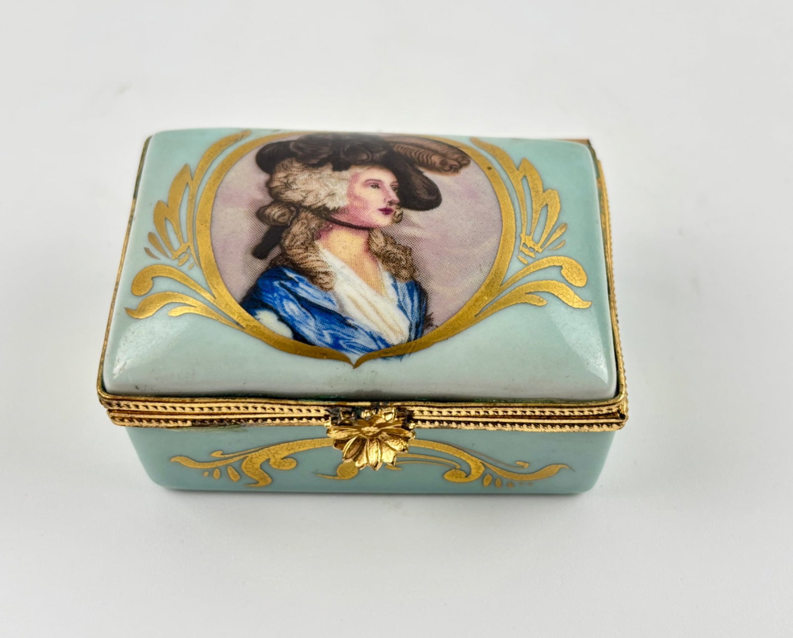 Limoges Portrait Porcelain Trinket Box : Rectangular porcelain trinket box marked ‘Limoges France’ on the underside. Features hand-painted portrait of a woman in period attire with gilt decoration on a pale blue background. Gold-