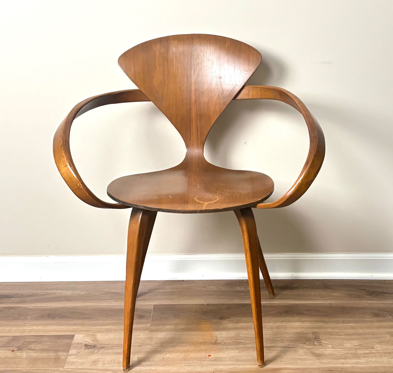 Norman Cherner for Plycraft ‘Pretzel’ Armchair : Norman Cherner ‘Pretzel’ armchair featuring molded bentwood construction with iconic curved armrests and tapered legs. Designed for Plycraft. The chair displays a rich wood finish with vis