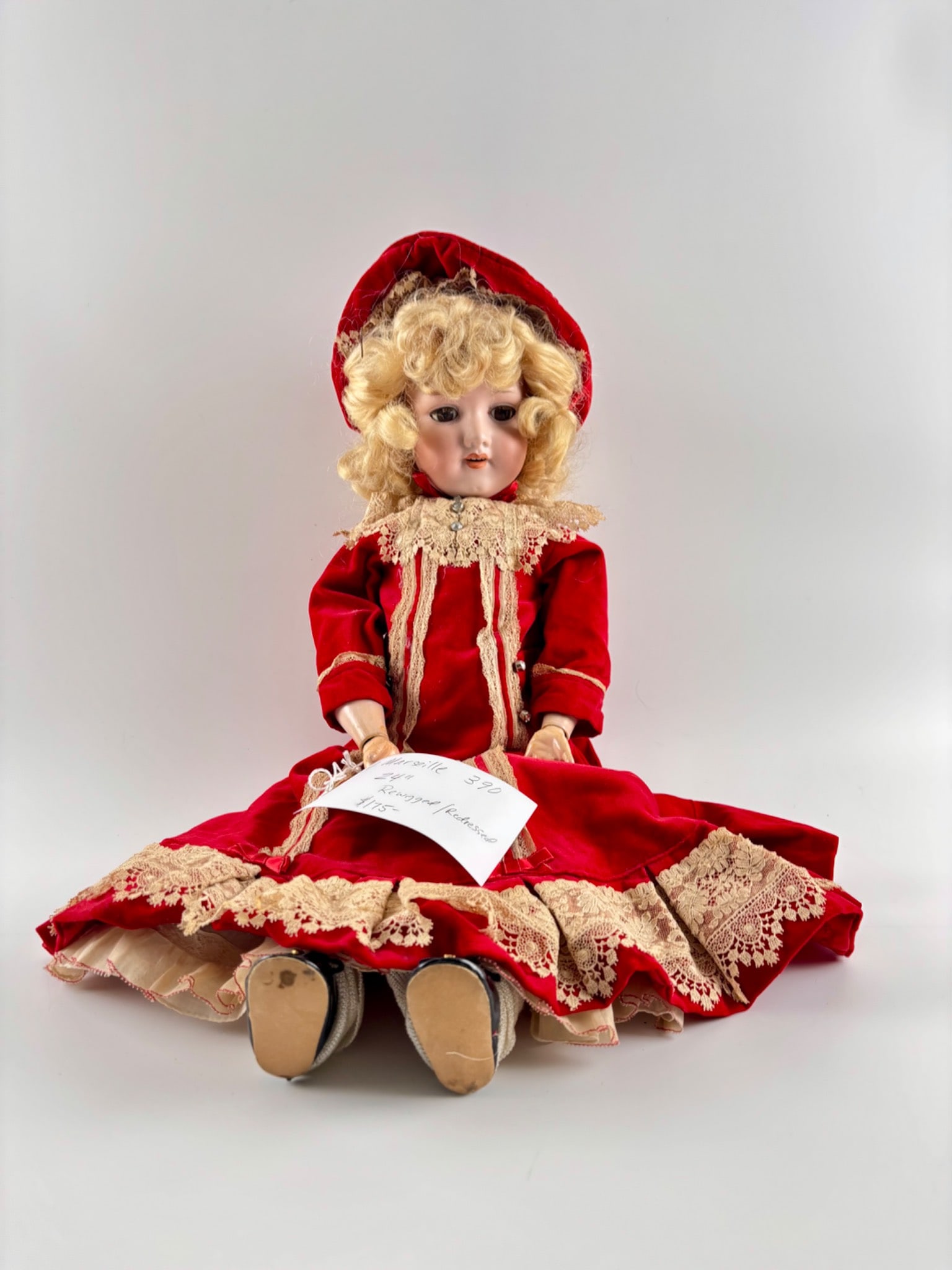 Armand Marseille 390 Bisque Head Doll 24 Inches: Armand Marseille 390 bisque head doll marked Made in Germany on the back of the neck. The 24 inch doll features a jointed composition body with some areas of wear and surface cracking. The doll has an