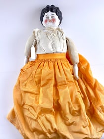 Antique Porcelain Head Doll with Cloth Body and Yellow Silk Skirt