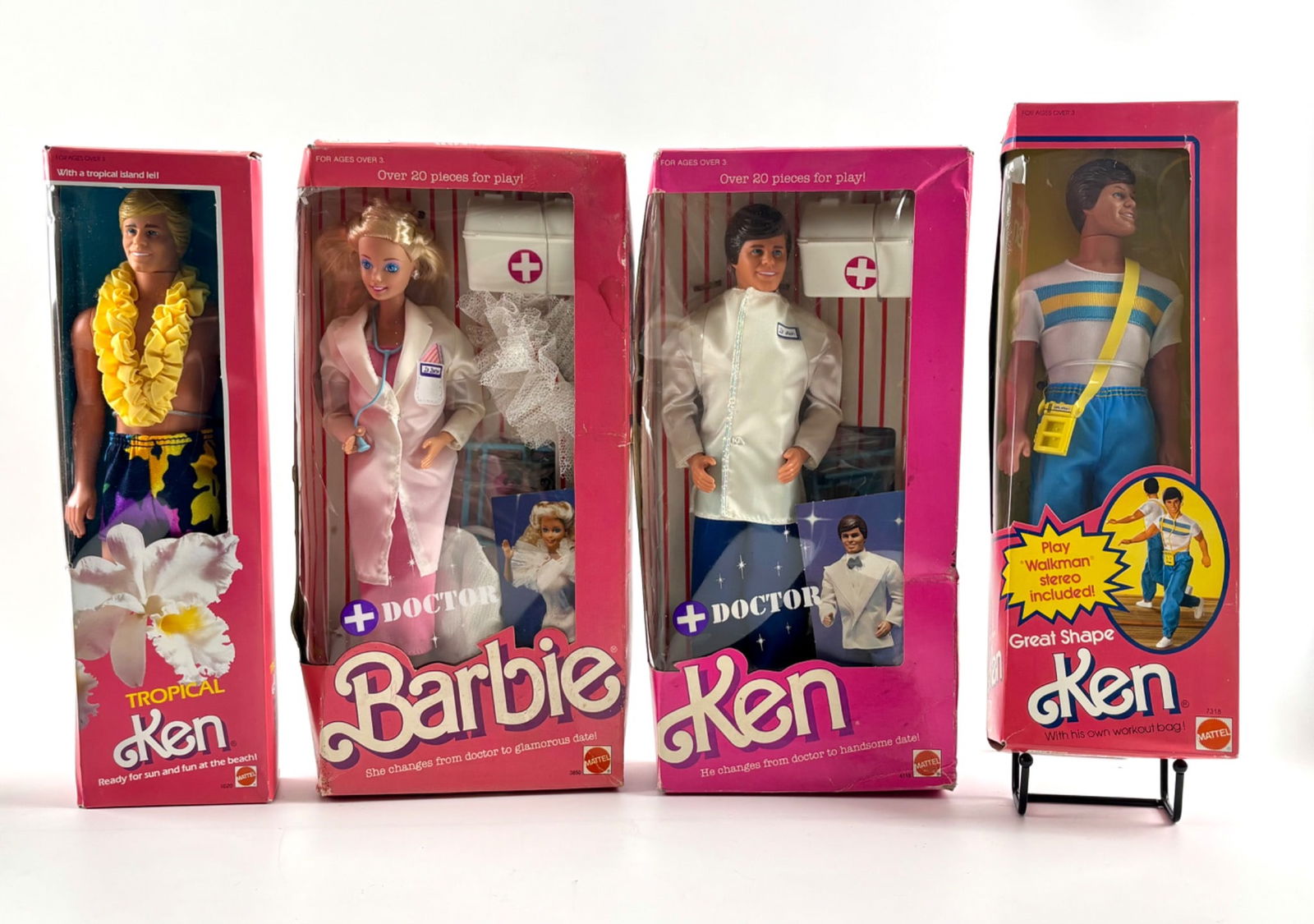 Vintage Mattel Barbie and Ken Dolls in Original Packaging: Four Mattel Barbie and Ken dolls in original packaging. Includes: 1 Doctor Barbie with doctor coat, stethoscope, and accessories; 1 Doctor Ken in medical attire with doctor bag; 1 Tropical Ken with fl