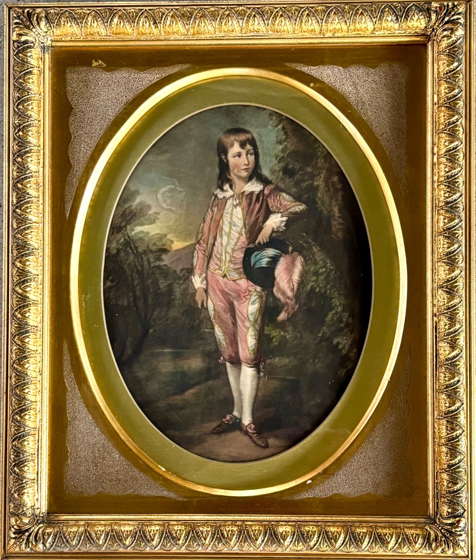 Antique Chromolithograph of Georgian Boy: Turn of the century chromolithograph depicting a Georgian boy dressed in period attire, featuring a pink jacket, breeches, and a plumed hat. The image shows a wooded landscape with a crescent moon in